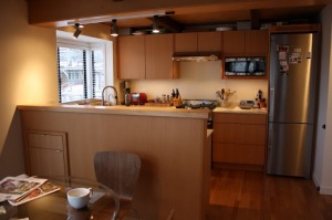 Vertical grain fir kitchen flat panel cabinetry and bar top.