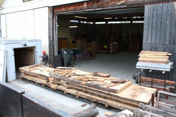 Cody begins unpacking wood from the kiln, which has been drying for 3 months at a temperature of 200 degrees. 