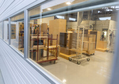 Custom cabinet doors drying on racks inside Smith & Vallee workshop